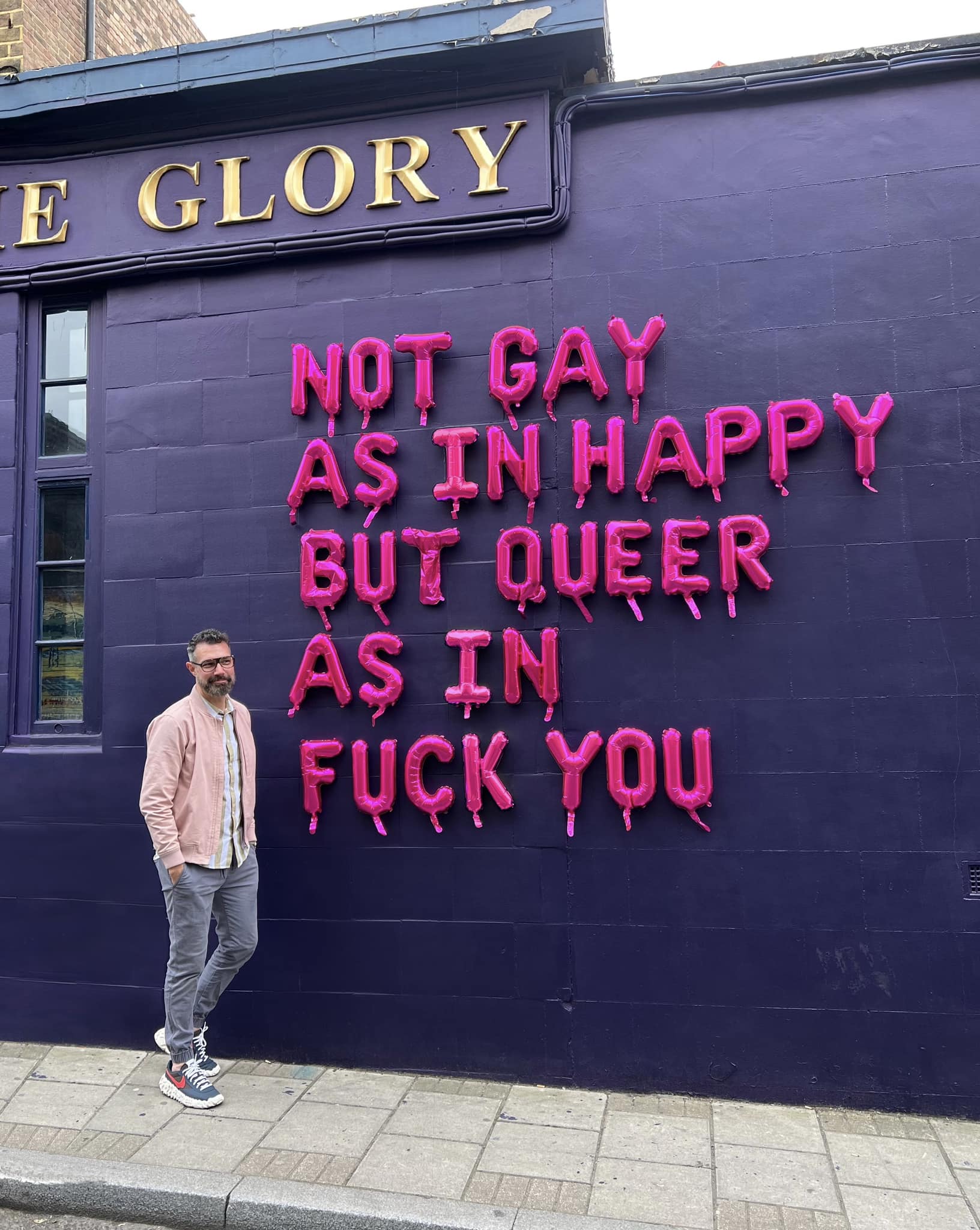 The meme is a photo of a man standing in front of a mural that reads "I'm not gay, I'm just not the 1% of the population that's gay, I'm the other 99% that's not gay". The image is a humorous commentary on the idea that someone is not gay because they are not part of the 1% of the population that identifies as gay, implying that the rest of the population is not gay.